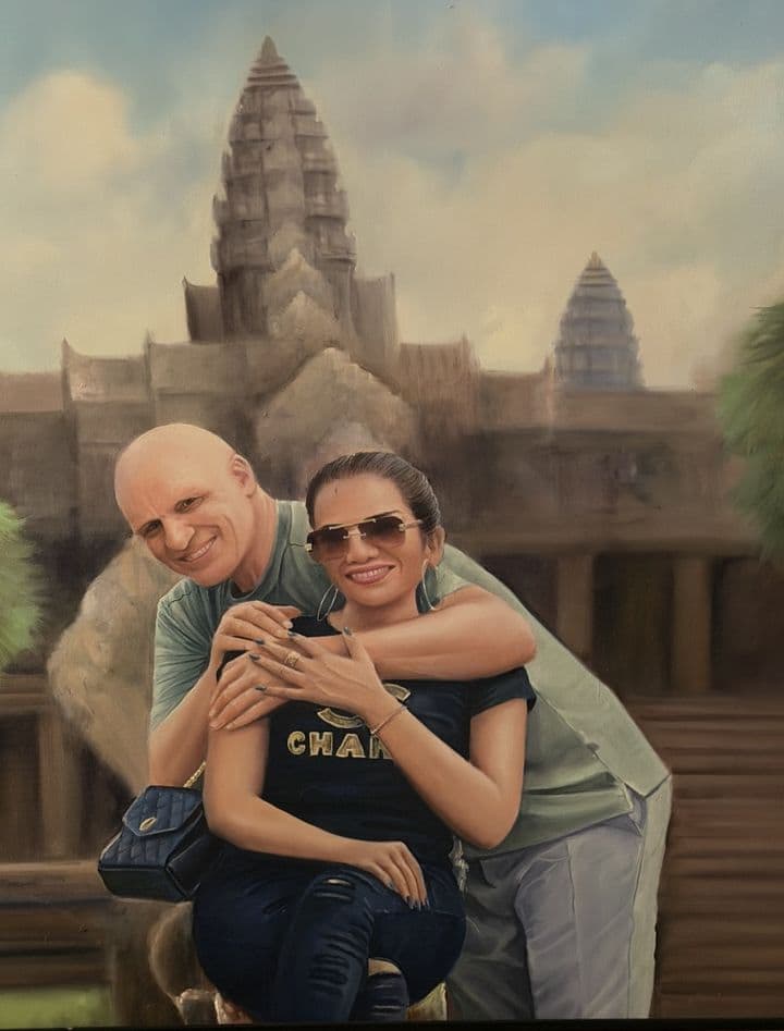 Custom oil painting of a couple embracing in front of Angkor Wat, hand-painted on canvas from a holiday photograph.
