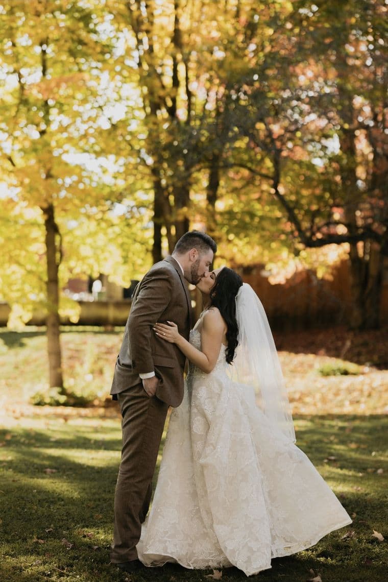 The original wedding photograph the couple sent to Velea, showing the bride and groom kissing outdoors in autumn.